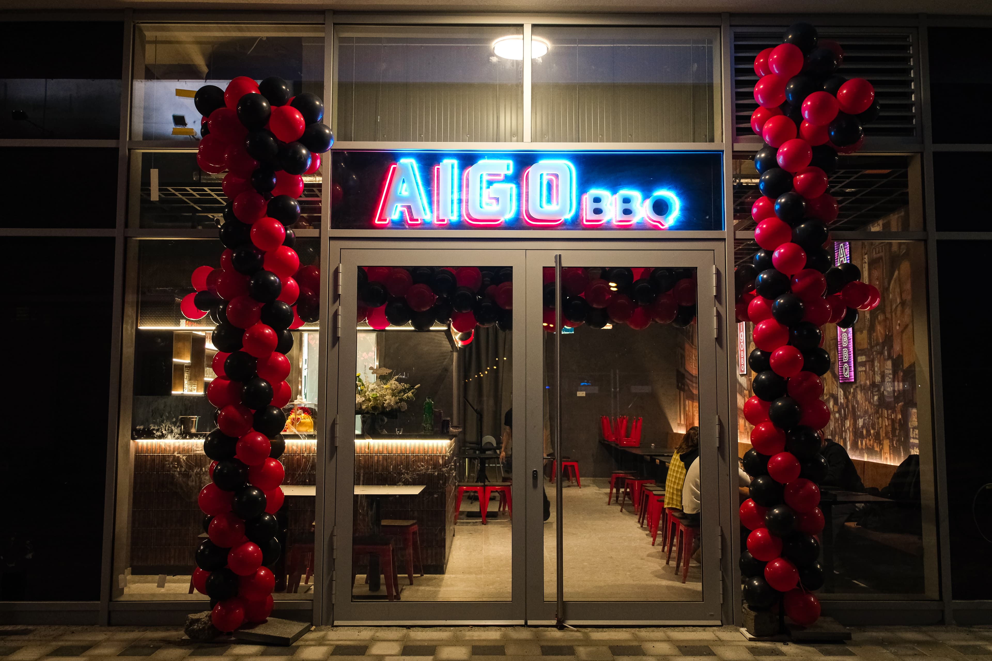 Aigo BBQ storefront at night